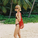 Young Woman in Bikini with Red Tote Bag on Tropical Beach
