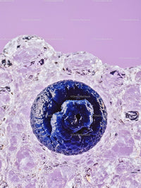 Fresh blueberry surrounded by sparkling bubbles on purple