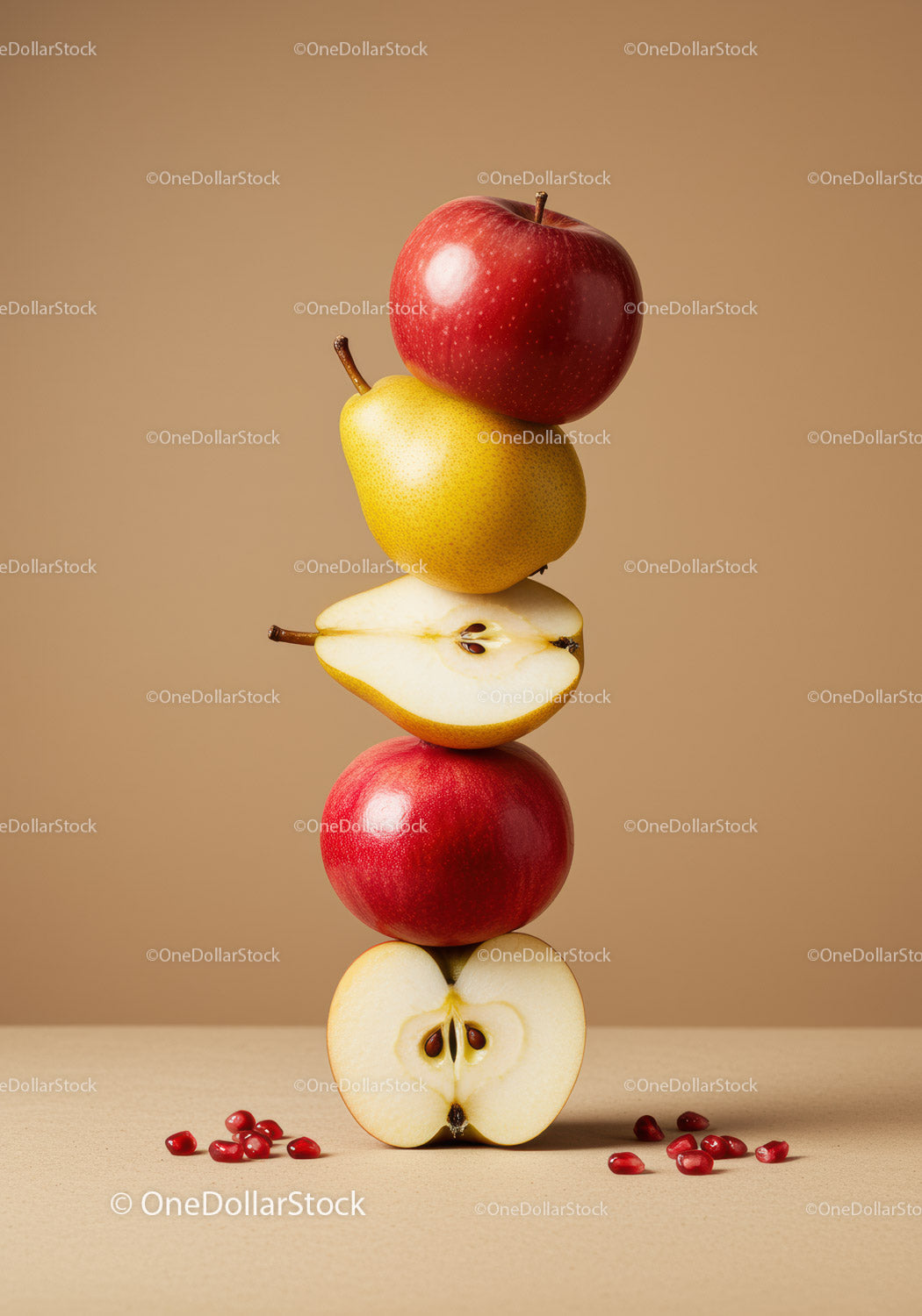 Stack of red apples and yellow pears on beige background