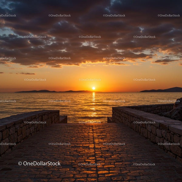 Serene Ocean Sunset with Cloudy Sky and Stone Pier