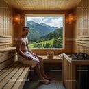 Relaxing Man Sitting in Wooden Sauna with Mountain View