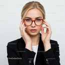 Elegant Woman in Red Glasses Wearing a Black Blazer