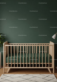 Modern Baby Crib in Cozy Nursery with Green Wall and Wooden Floor