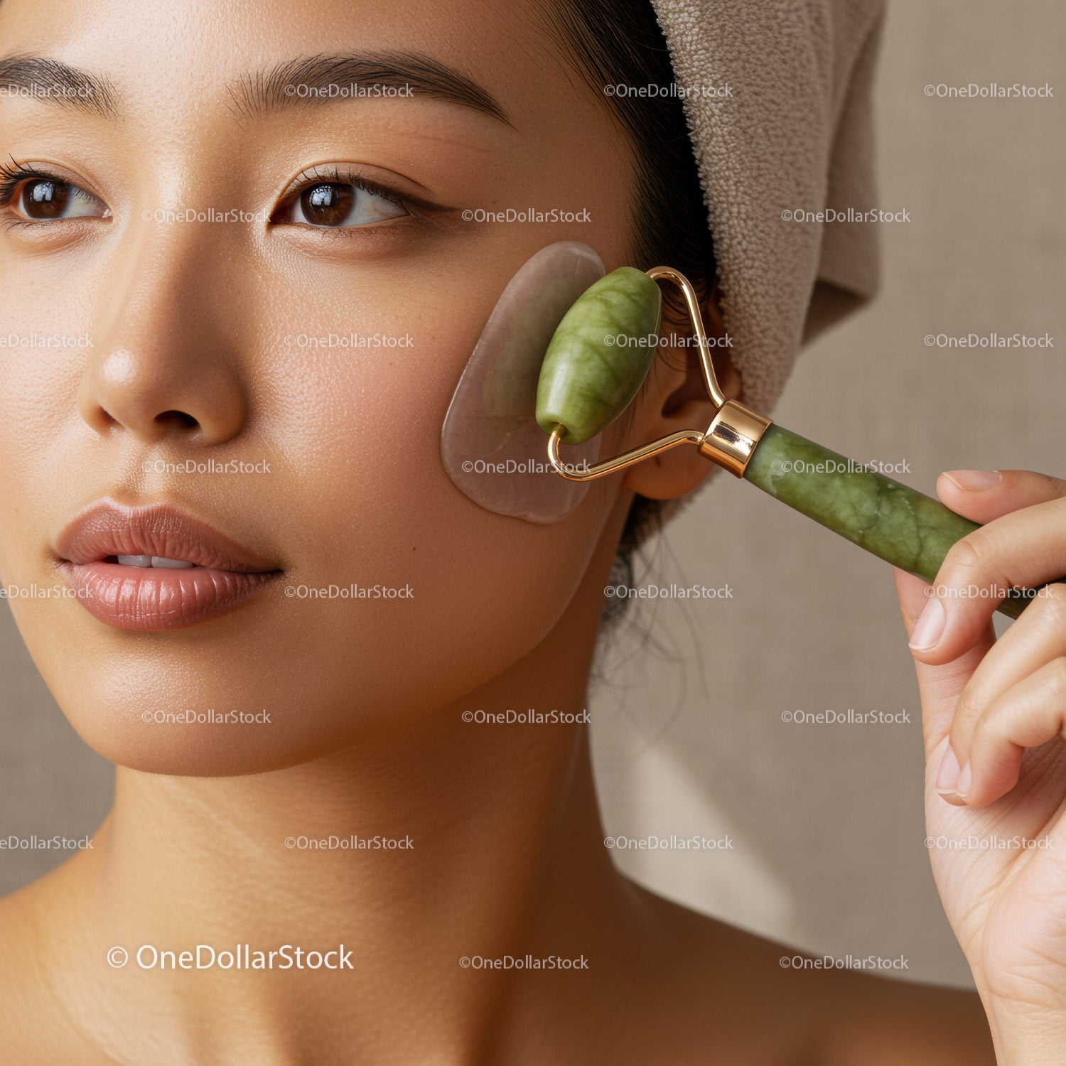 Close-Up of Asian Woman Using Jade Roller for Facial Massage