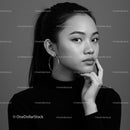 Elegant Black and White Portrait of a Young Woman with Hoop Earrings