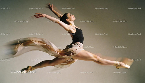 Graceful ballet dancer performing a soaring leap