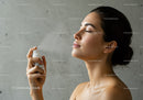 Young Woman Spraying Facial Mist for Hydration and Refreshment
