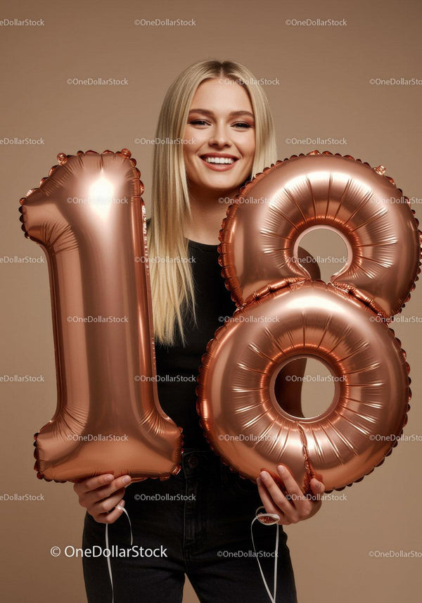 Smiling young woman celebrating 18th birthday with balloons