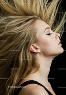 Blonde woman with flowing hair and closed eyes profile