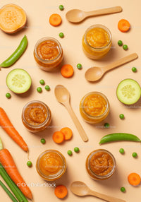 Assorted vegetable purees in jars with fresh produce