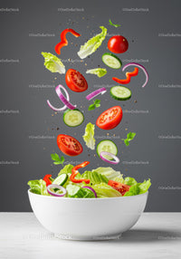 Fresh Vegetable Salad Ingredients Floating Above Bowl