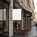 Cozy street cafe with empty signboard on historic city sidewalk