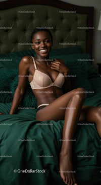 Smiling woman relaxing on bed in beige lingerie
