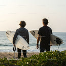 Two Surfers with Surfboards at Beach Ready for Waves