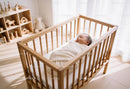 Peacefully Sleeping Baby Swaddled in Wooden Crib