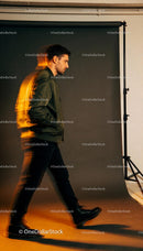 Man in green jacket walking with motion blur effect