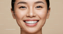 Close up of smiling young Asian woman with flawless skin