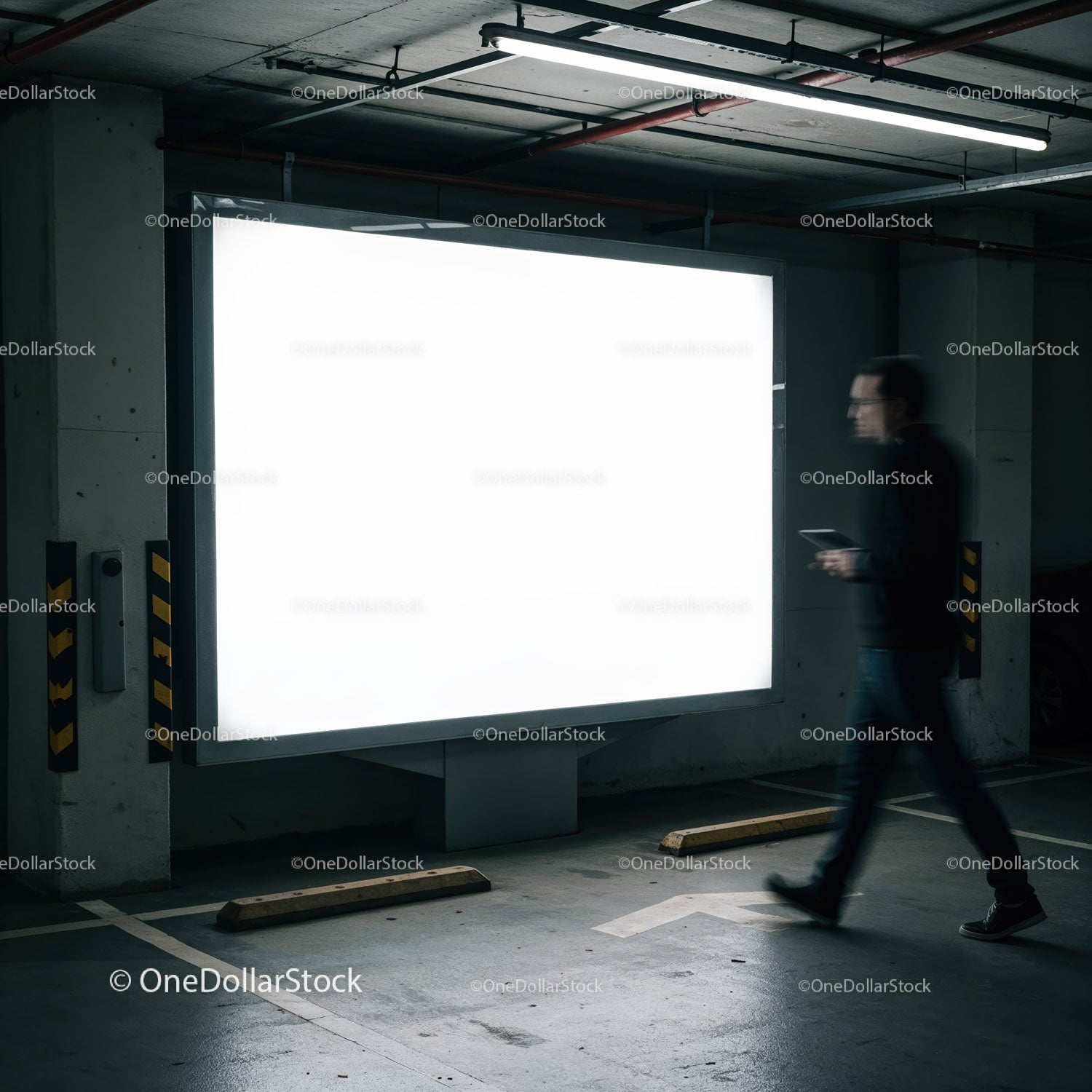 Blurred man walking near bright billboard in parking garage