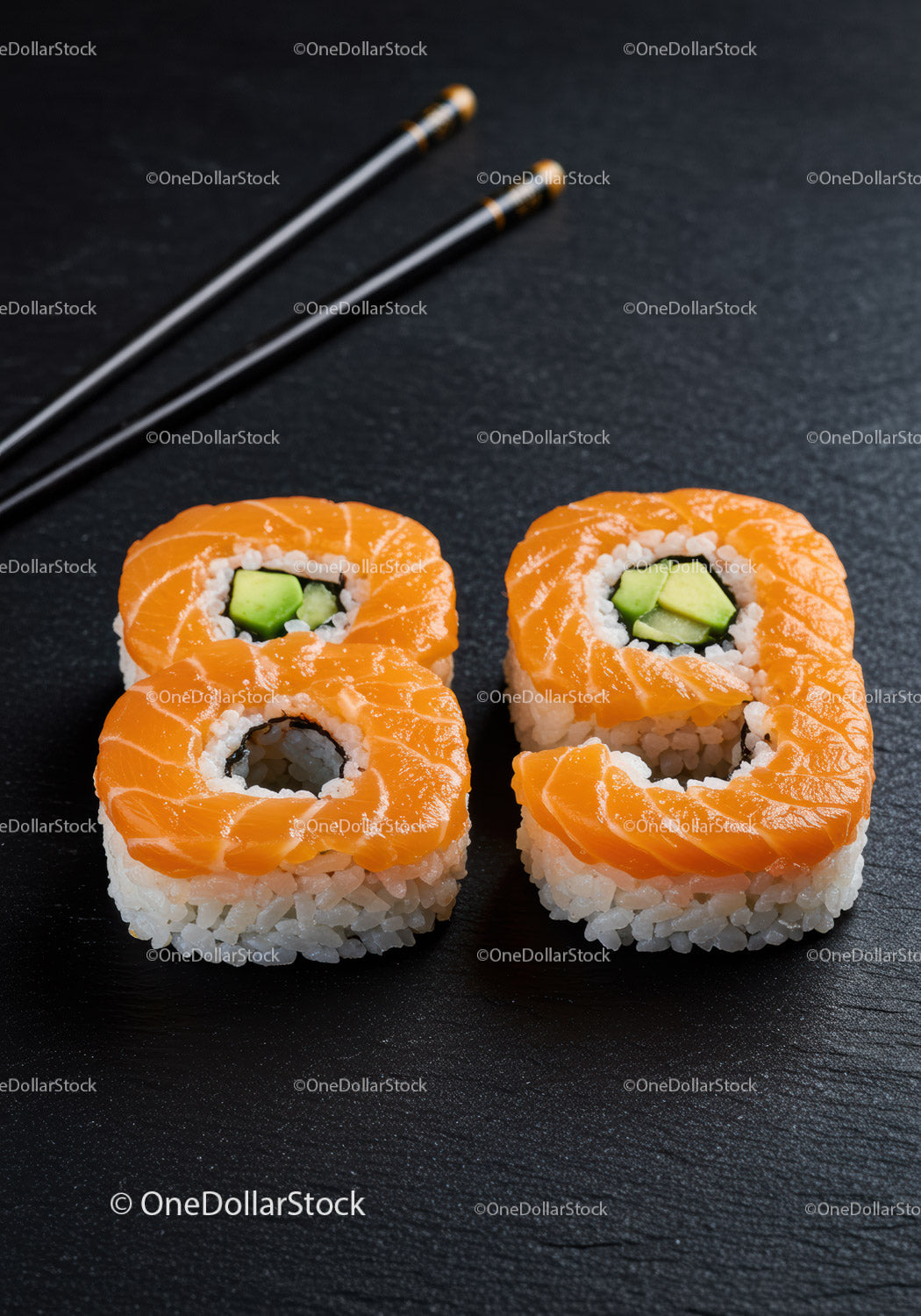 Fresh salmon avocado sushi rolls with chopsticks closeup