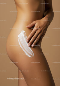 Elegant Woman Applying Body Lotion Highlighting Smooth Skin and Femininity