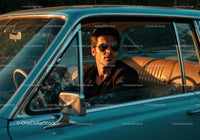 Stylish Man Wearing Sunglasses in Classic Blue Car During Sunset
