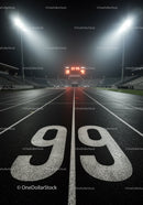 Empty illuminated running track at night with scoreboard
