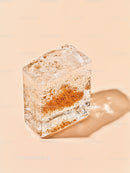 Close up of textured ice cube with embedded particles