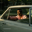 Young Man in Pink Shirt Sitting in Vintage Car on a Sunny Day