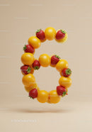 Number six formed by fresh oranges and strawberries