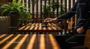 Hand Holding Coffee Cup in a Cozy Cafe Surrounded by Plants