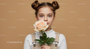 Young Girl Holding Peach Rose with Brown Hair in Space Bun