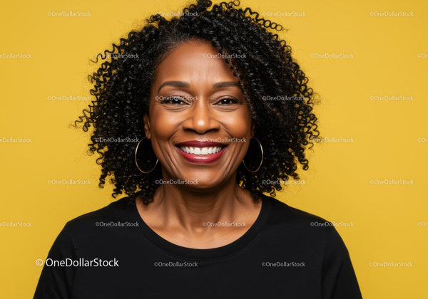 Portrait of a Smiling Woman with Curly Hair and Hoop Earrings Against Yellow Background