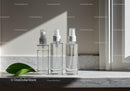 Three Transparent Spray Bottles on Marble Surface