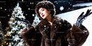 Elegant woman in fur coat enjoying snowy winter night