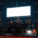 Empty illuminated billboard over cityscape at night