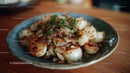 Seared Scallops with Caramelized Onions and Herbs on Rustic Plate