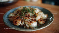 Seared Scallops with Caramelized Onions and Herbs on Rustic Plate