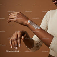 Diverse Woman Applying Lotion for Skin Moisturization and Body Care