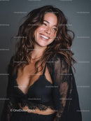 Portrait of a Smiling Woman in Black Lace Lingerie with Wavy Hair
