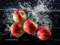 Fresh Red Apples Splashing into Water in Dynamic Motion