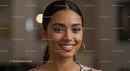 Smiling Woman with Gold Hoop Earrings and Natural Makeup