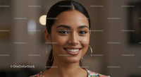 Smiling Woman with Gold Hoop Earrings and Natural Makeup