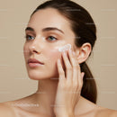Young Woman Applying Facial Moisturizer for Glowing Skin