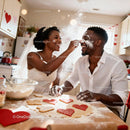 Joyful couple baking heart shaped cookies together