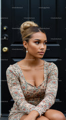 Young woman sitting thoughtful by black door