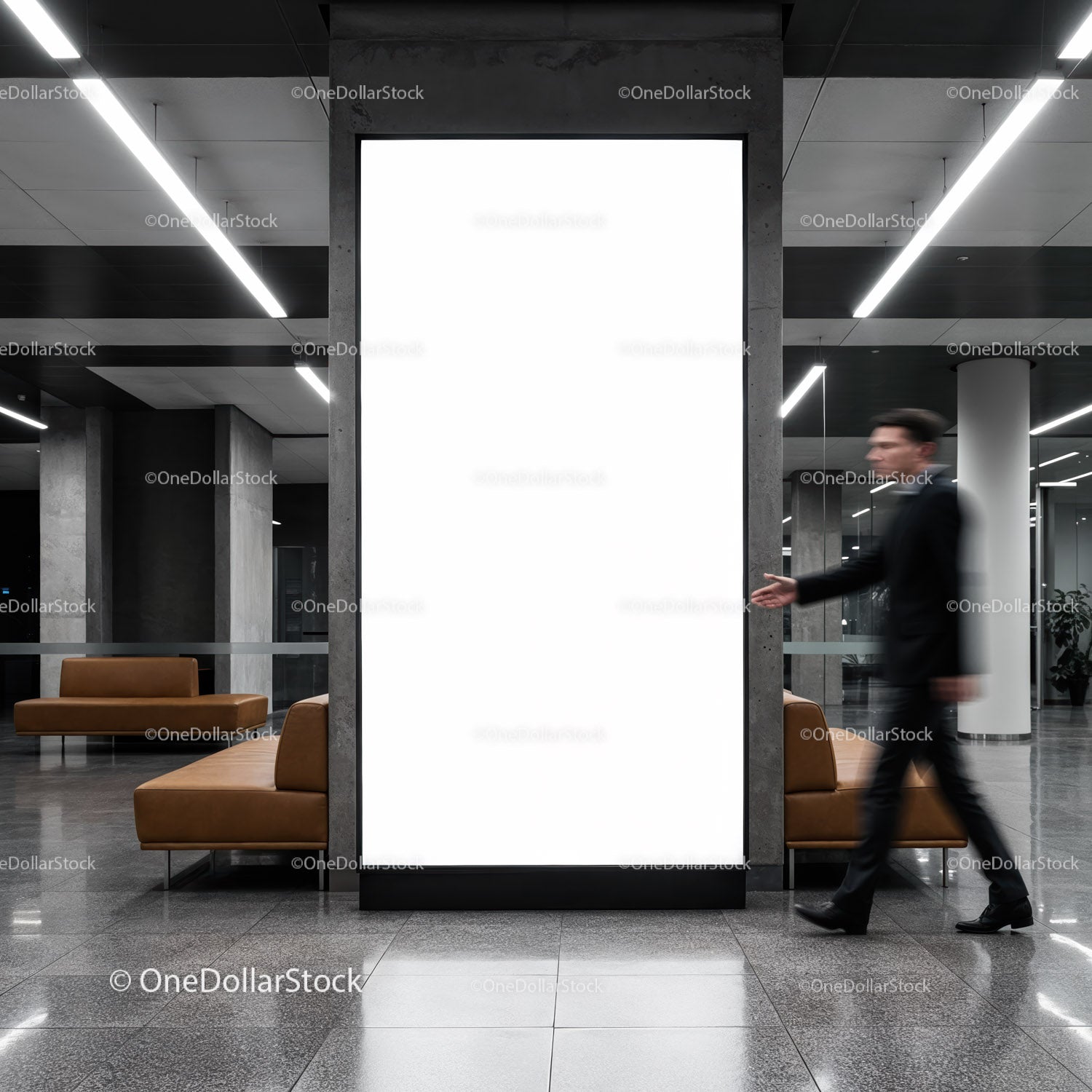Businessman walking past empty modern lobby billboard