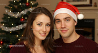 Young couple smiling near decorated Christmas tree