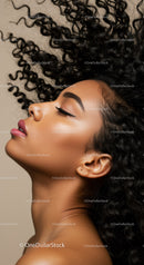 Serene woman with curly hair and closed eyes portrait