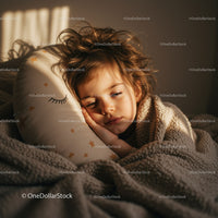 Peaceful child resting with cozy blanket in warm light