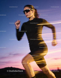 Athletic woman running at sunset in sleek sportswear